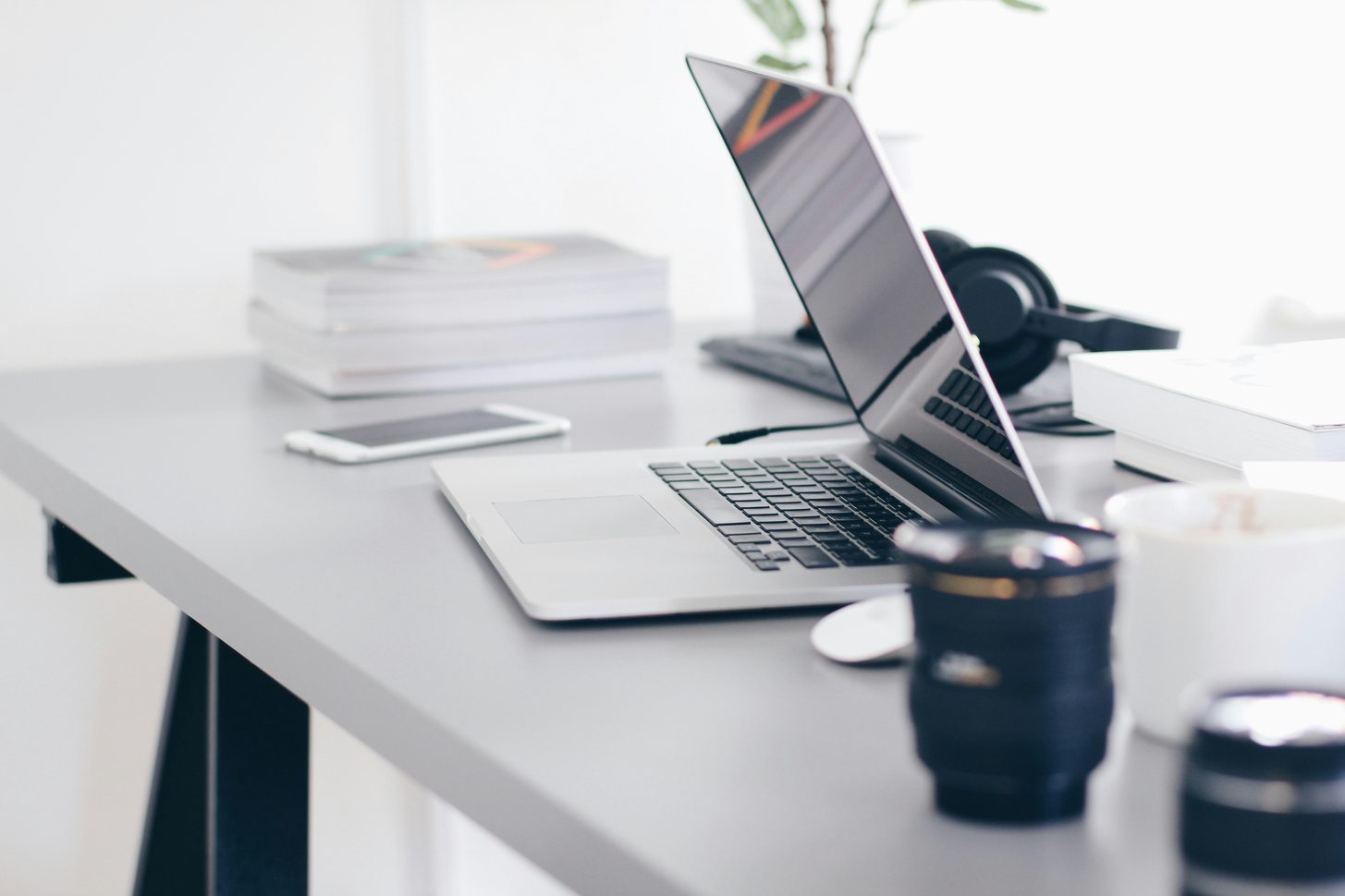 Two people reviewing printed spreadsheets and a laptop across a small table